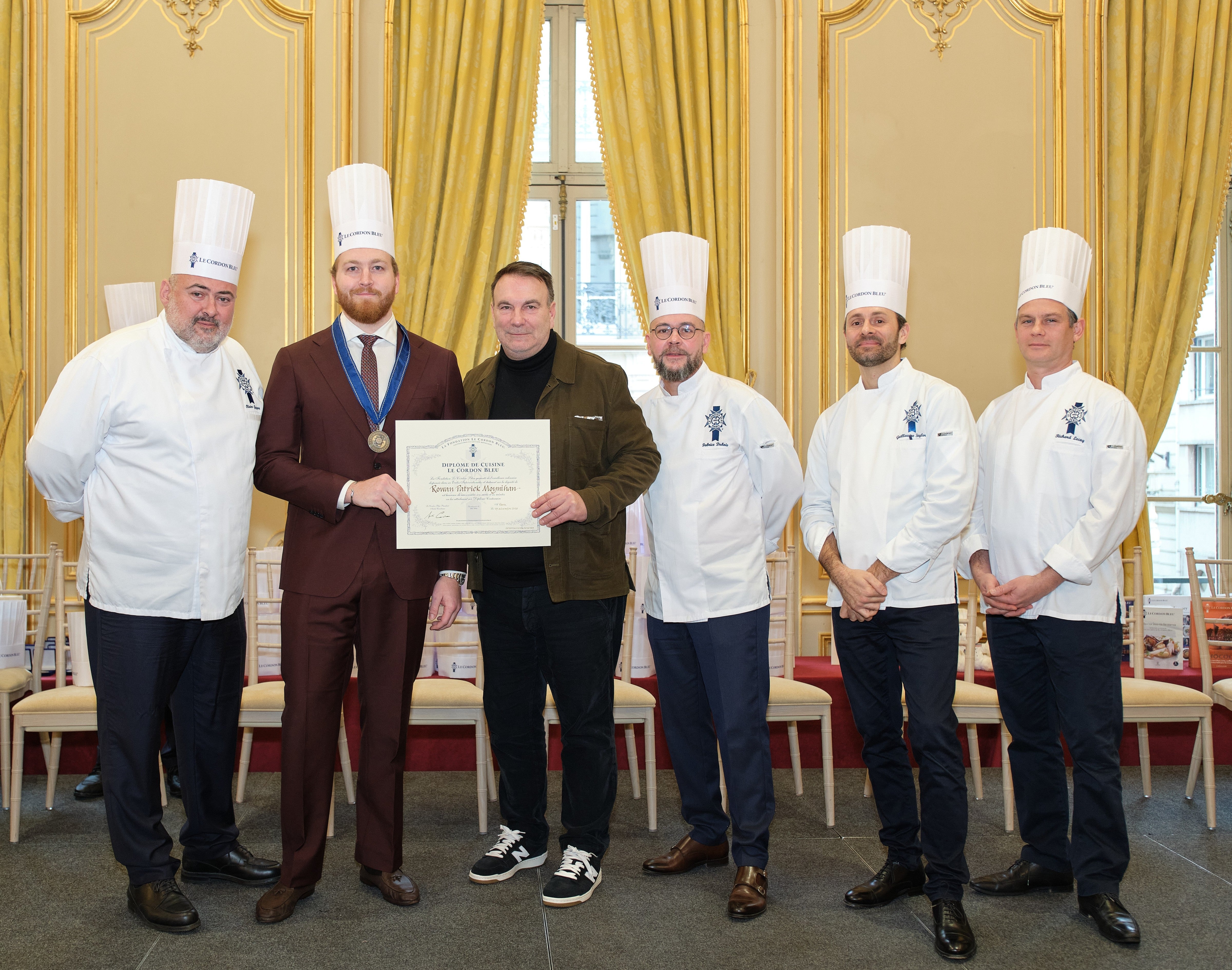 Rowan Moynihan receiving his Diplome de Cuisine at Le Cordon Bleu Paris with the chef brigade