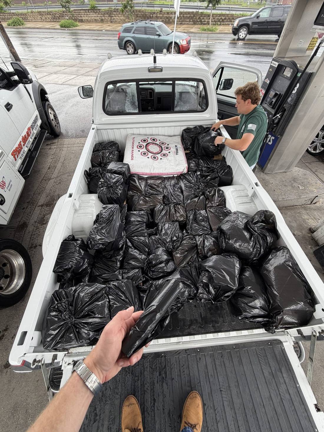 The first run of VIOLET covered in trash bags in a pickup truck bed during a rainstorm